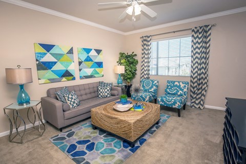 a living room with couches and a coffee table at Loreto & Palacio Apartments, Las Vegas, NV 89149